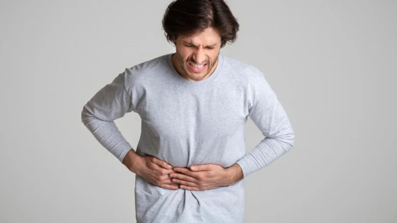 Man holding stomach in pain
