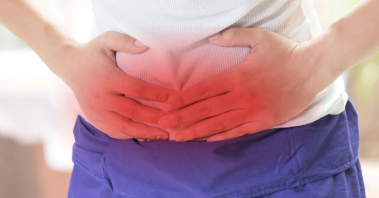 Person holding stomach in pain