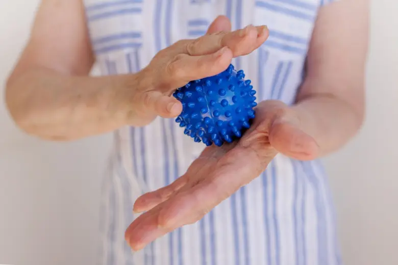 Ruční cvičení s modrým masážním koulem pro Parkinsonovu chorobu
