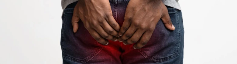 Hands on buttocks pain area