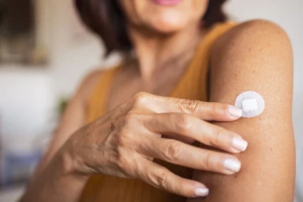 Woman with patch on arm