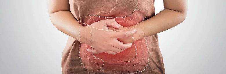 Woman holding abdomen with colon overlay