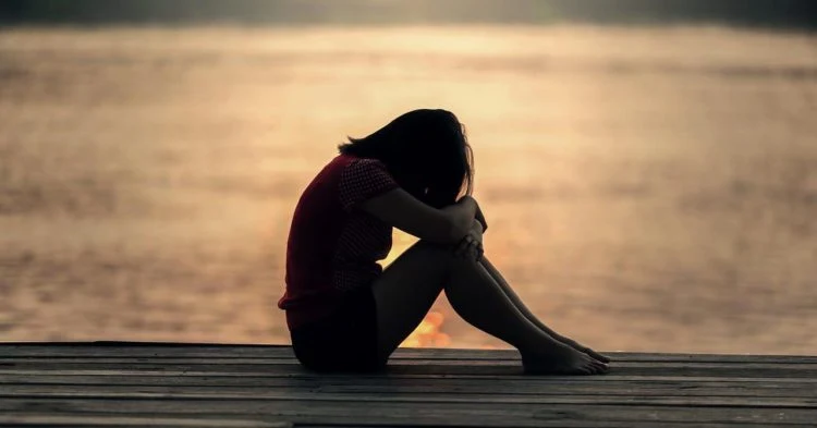 Sad person on dock