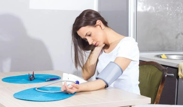 Woman measuring blood pressure
