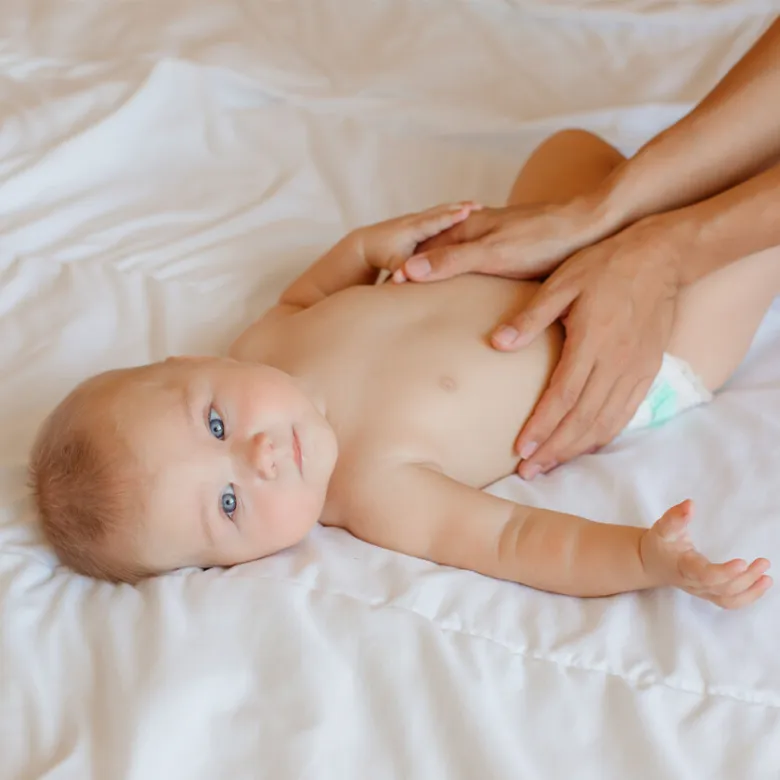 Baby receiving belly massage