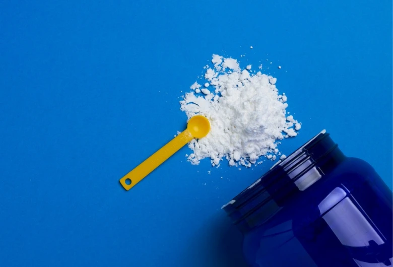 Creatine powder and scoop