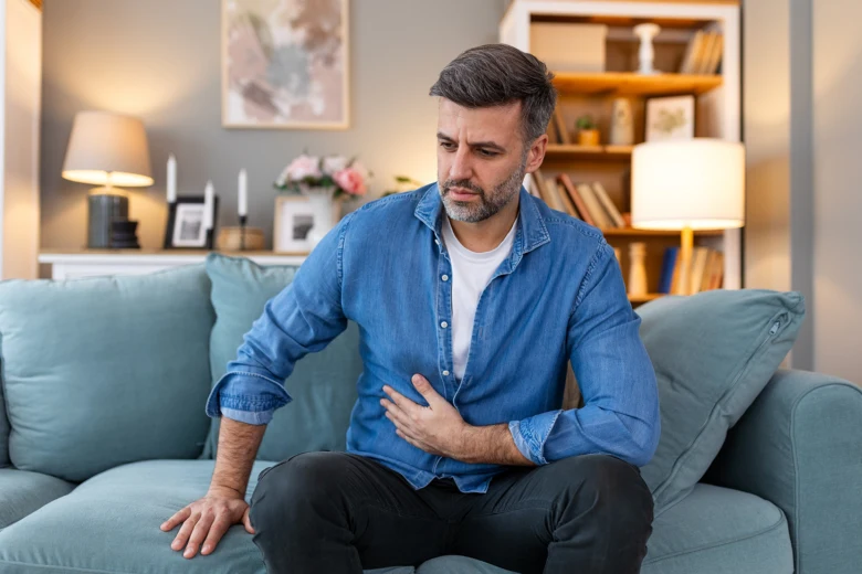 Man clutching chest in pain