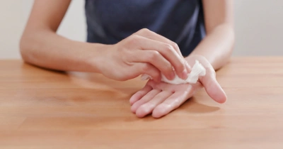 Person applying cream to hand