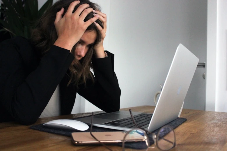 Woman with headache at desk