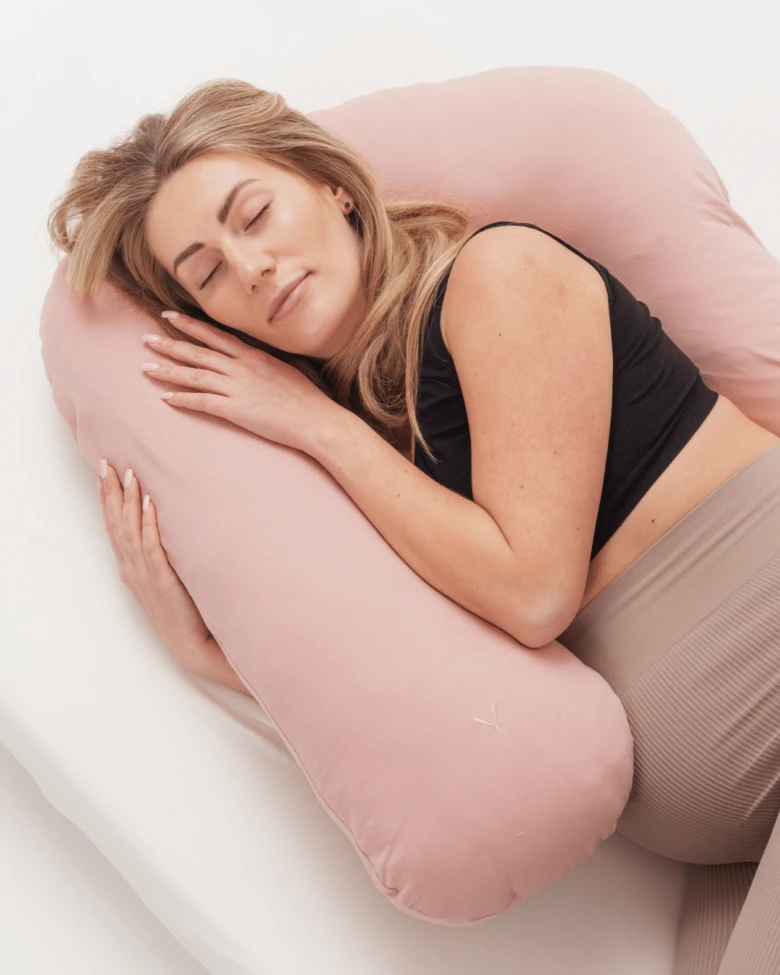 Pregnant woman sleeping with pillow